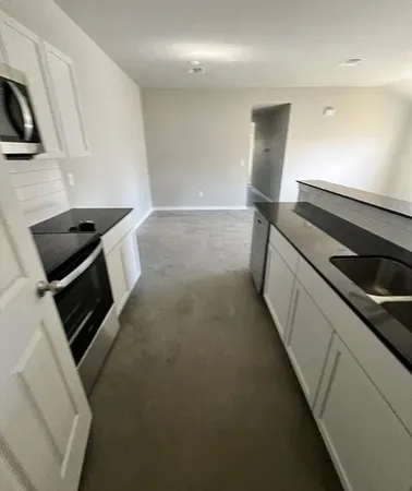 a kitchen with a stove and a refrigerator