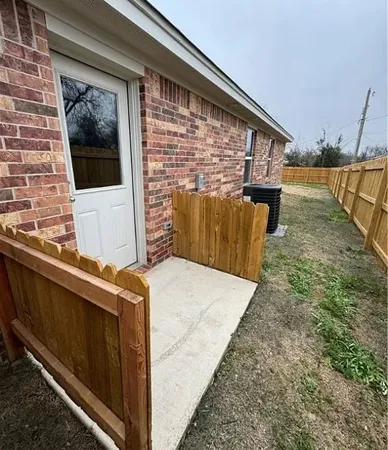 a view of a balcony with wooden floor and fence