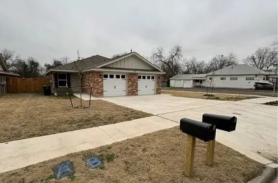 a front view of a house with a yard and seating space
