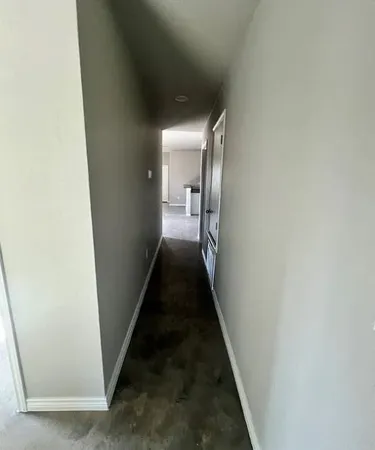 a view of a hallway with a white walls