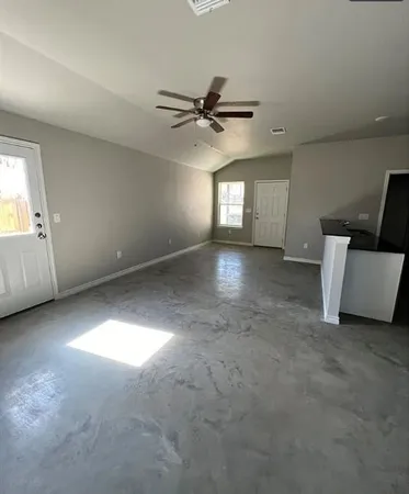 an empty room with a empty space and windows