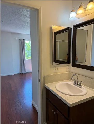 a bathroom with 2 sink and a mirror
