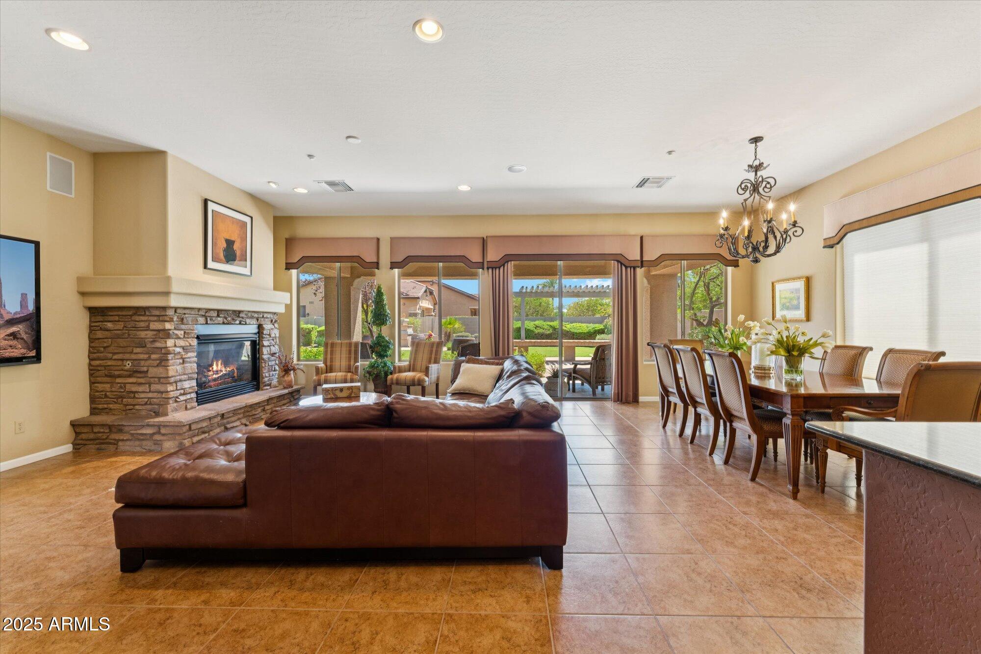 4959 North Village Road Litchfield Park, AZ 85340 - Photo 12 of 55 a living room with fireplace furniture and a large window