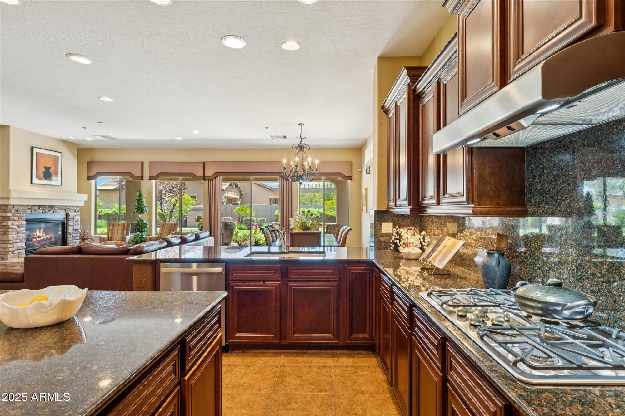 4959 North Village Road Litchfield Park, AZ 85340 - Photo 21 of 55 a kitchen with stainless steel appliances granite countertop a stove and a sink
