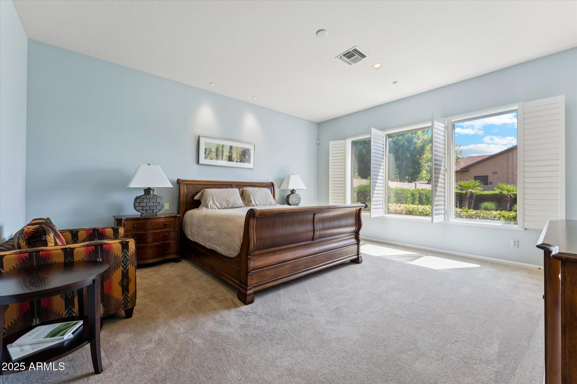 4959 North Village Road Litchfield Park, AZ 85340 - Photo 28 of 55 a bedroom with a bed and a window