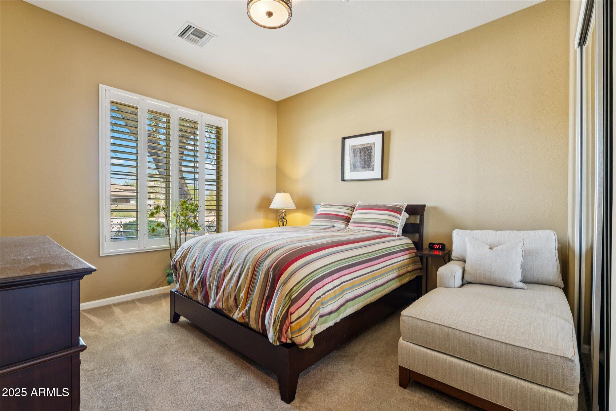 4959 North Village Road Litchfield Park, AZ 85340 - Photo 34 of 55 a bedroom with a bed and a window