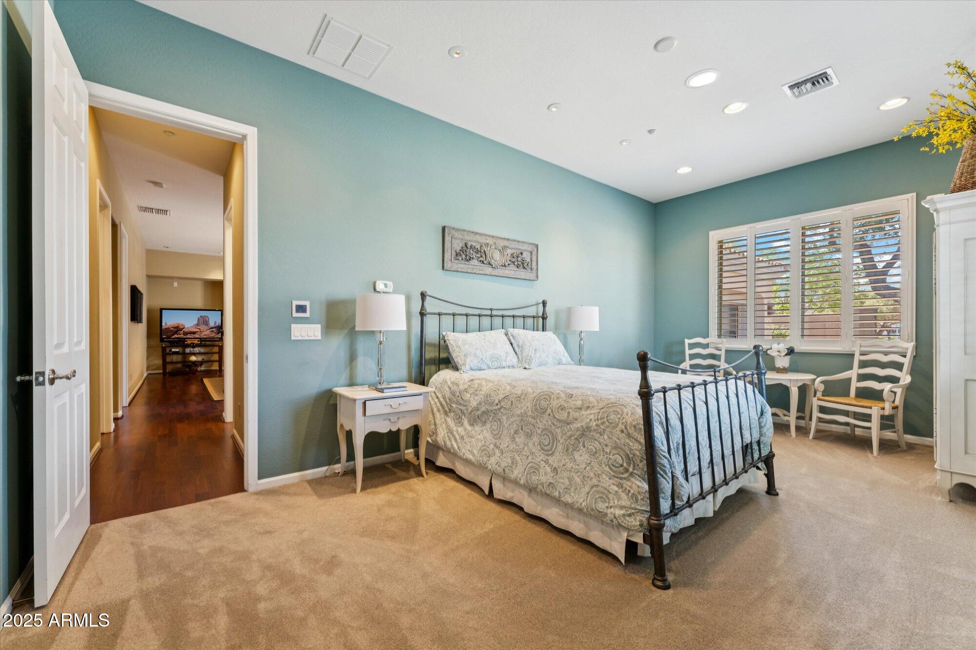 4959 North Village Road Litchfield Park, AZ 85340 - Photo 35 of 55 a bed room with a bed and a chair