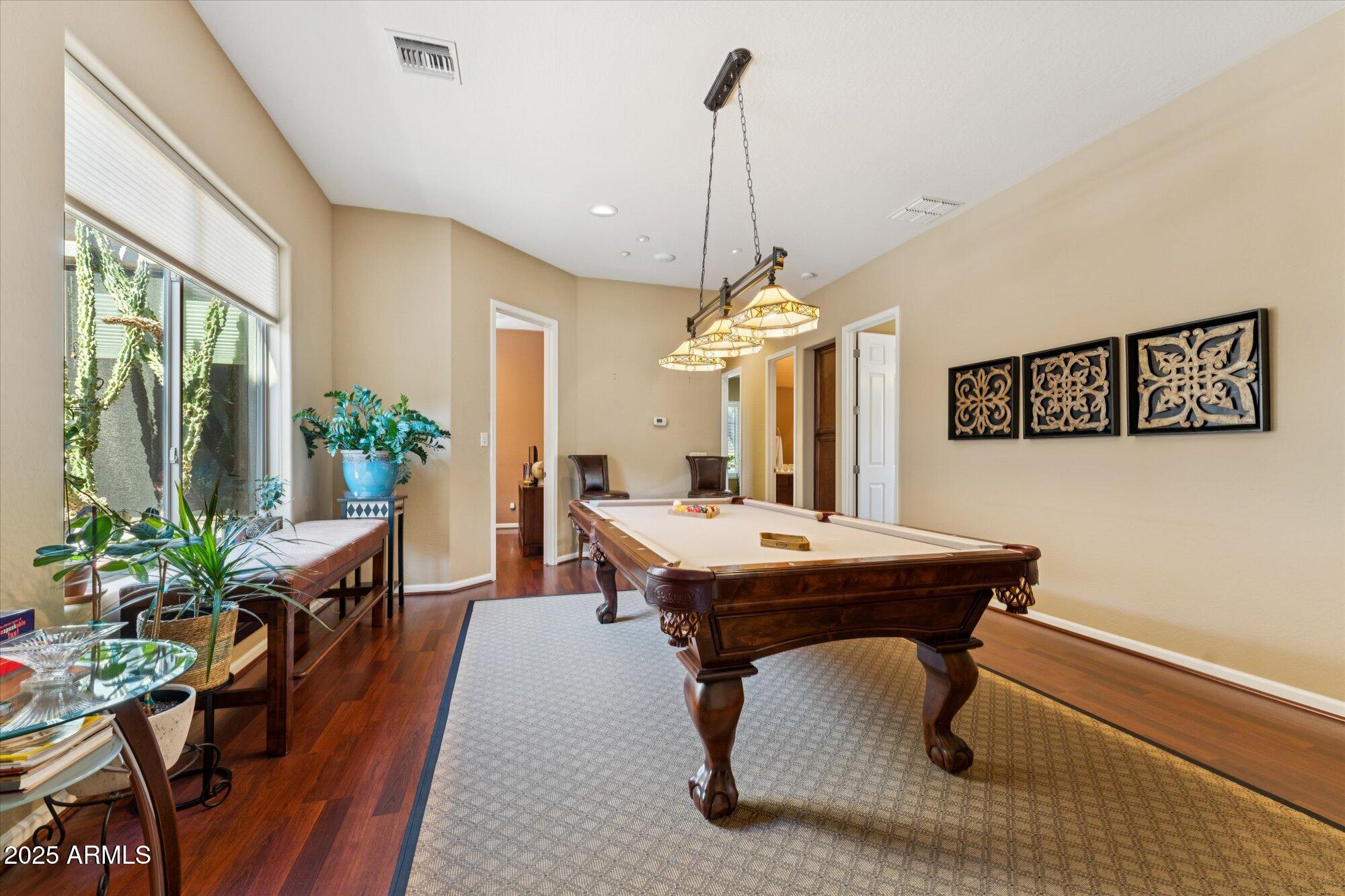 4959 North Village Road Litchfield Park, AZ 85340 - Photo 37 of 55 a dining room with furniture a chandelier and wooden floor