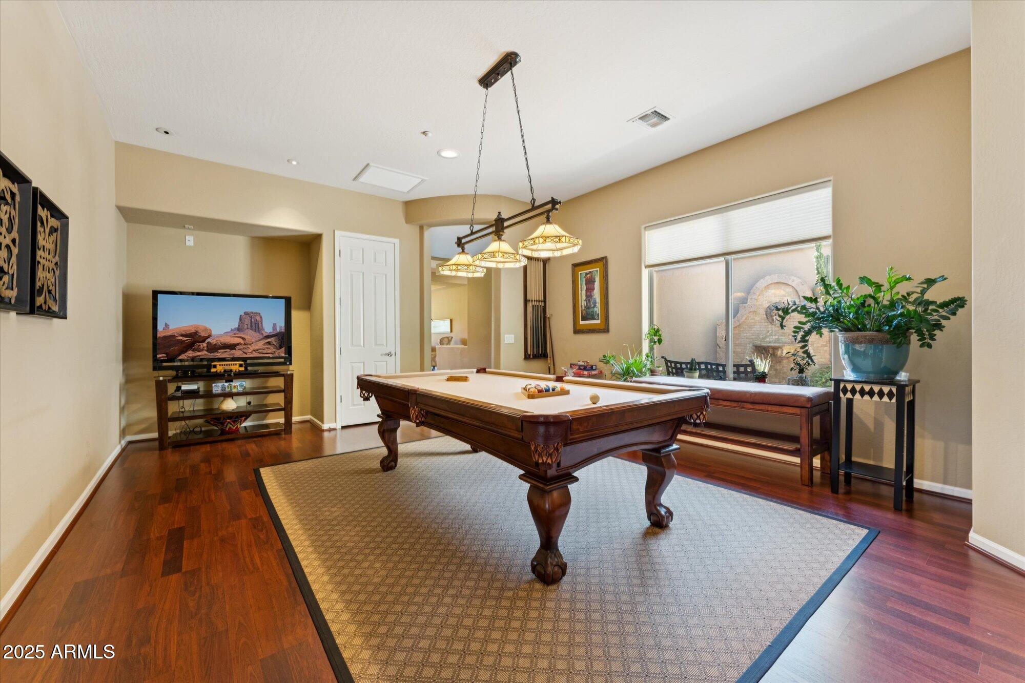 4959 North Village Road Litchfield Park, AZ 85340 - Photo 38 of 55 a living room with furniture a table and potted plants