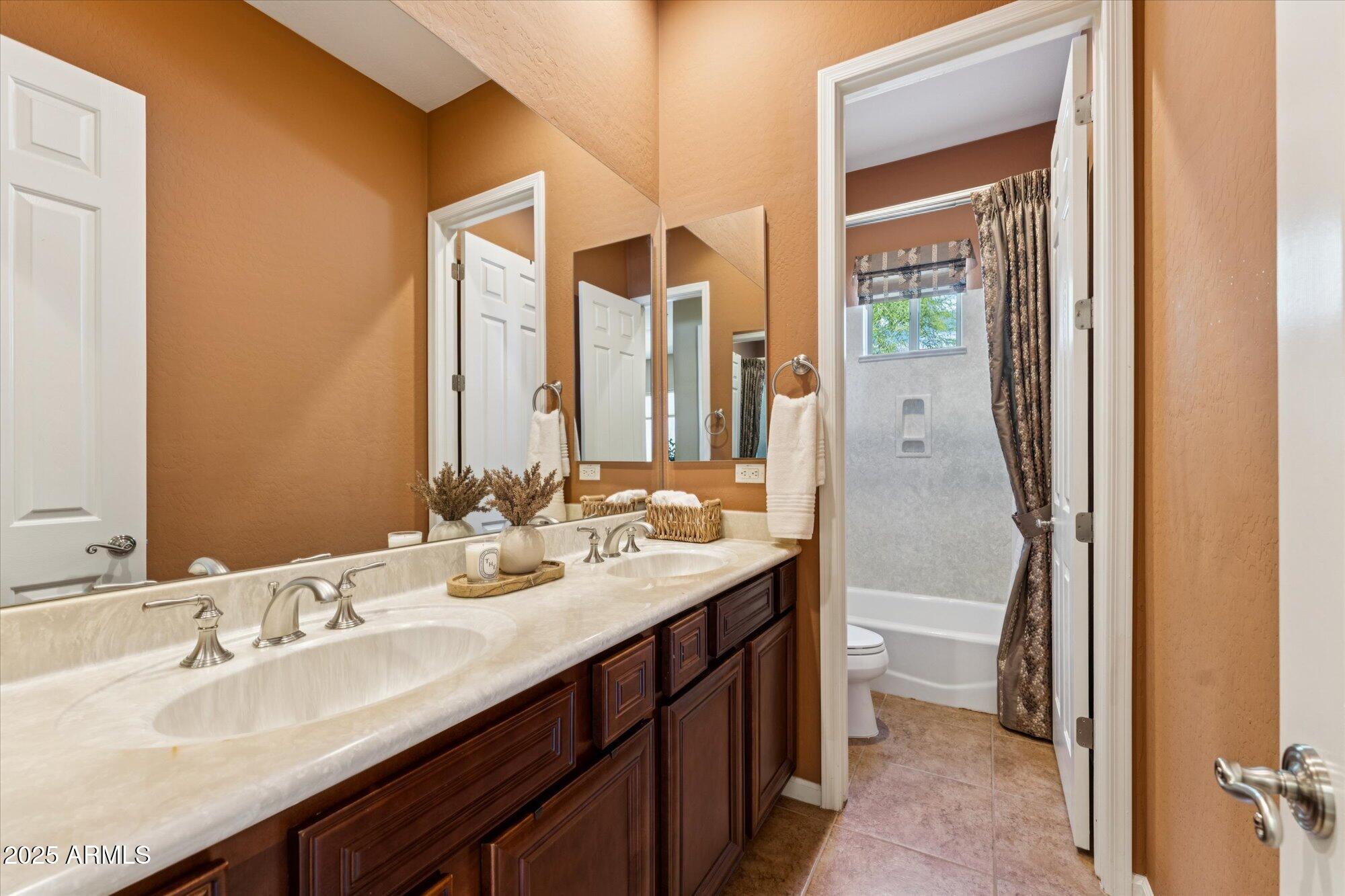 4959 North Village Road Litchfield Park, AZ 85340 - Photo 41 of 55 a bathroom with a double vanity sink mirror and double