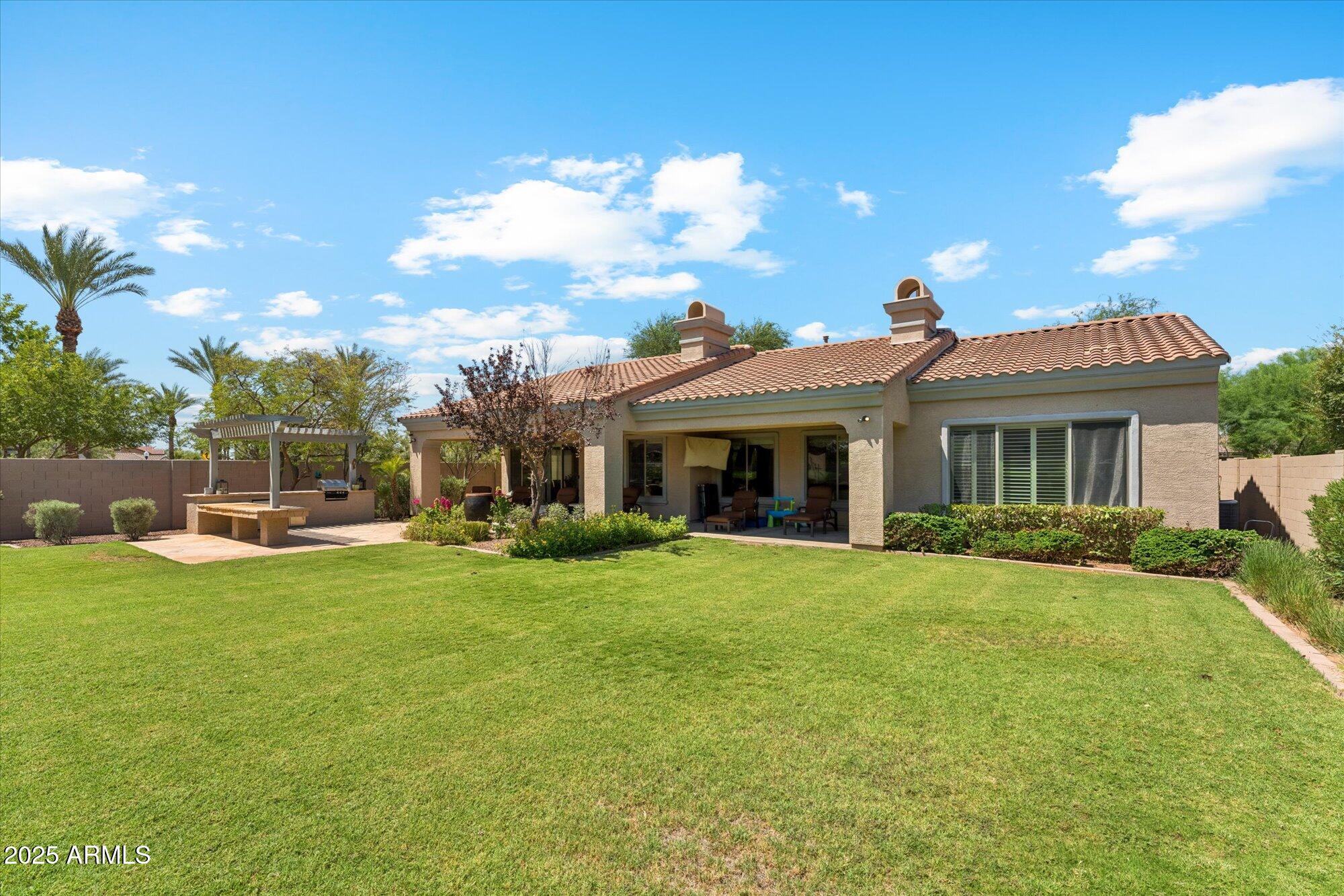 4959 North Village Road Litchfield Park, AZ 85340 - Photo 44 of 55 a front view of a house with swimming pool having outdoor seating