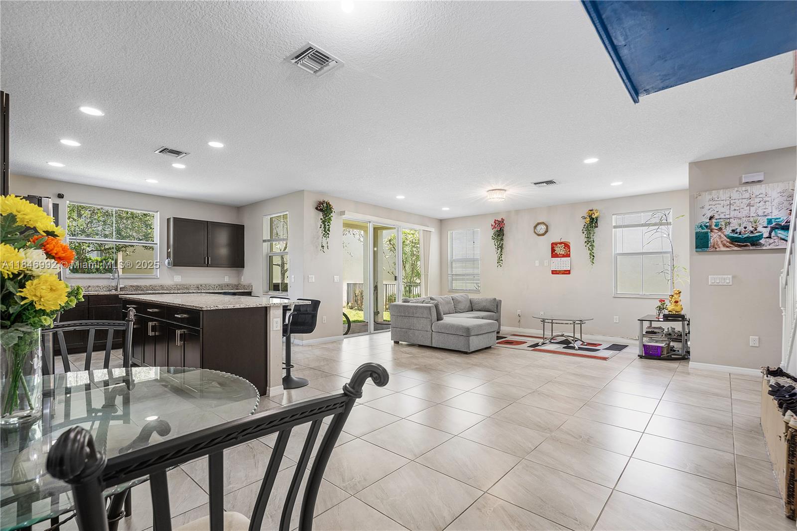 6411 Osprey Landing Street Davie, FL 33314 - Photo 18 of 38 a living room with furniture and a flat screen tv