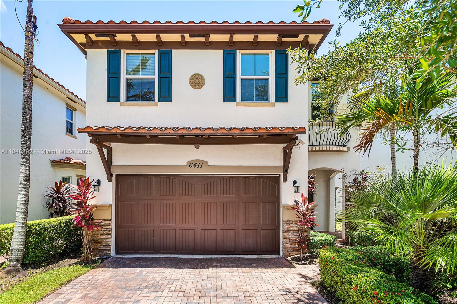 6411 Osprey Landing Street Davie, FL 33314 - Photo 2 of 38 a front view of a house with plants