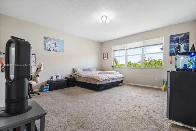 a bedroom with furniture and a window