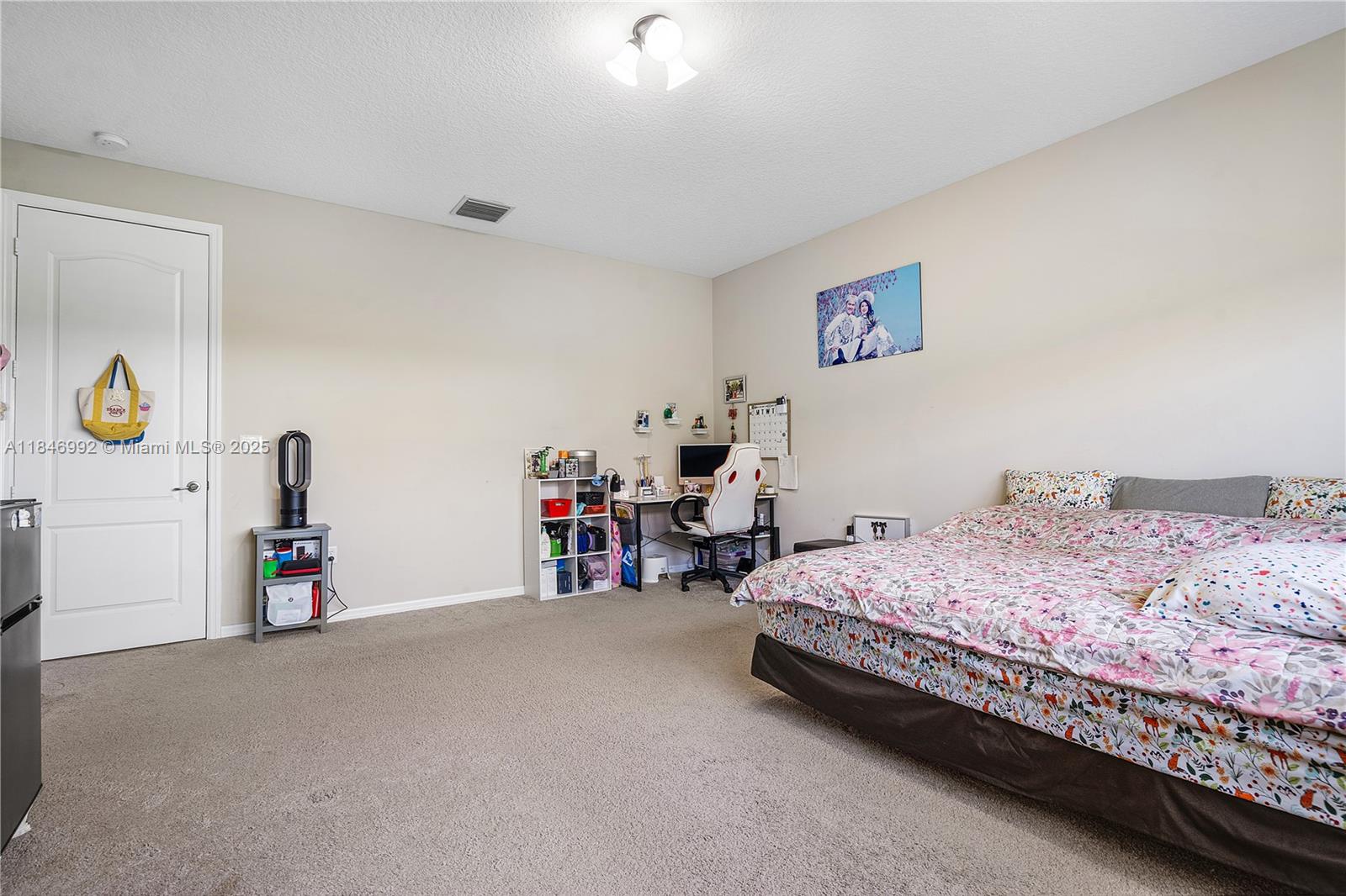 6411 Osprey Landing Street Davie, FL 33314 - Photo 23 of 38 a bedroom with a bed and a desk