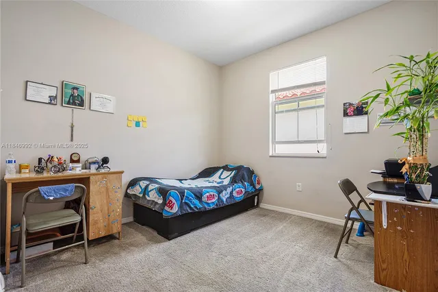 a bedroom with furniture and a window
