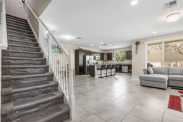 a lobby with furniture and stairs