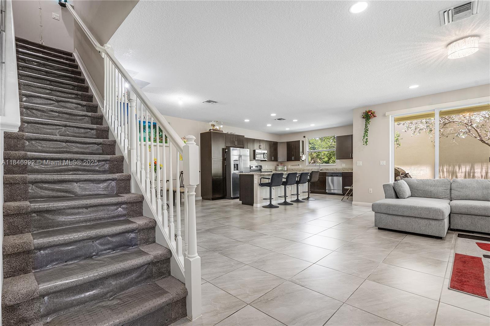 6411 Osprey Landing Street Davie, FL 33314 - Photo 6 of 38 a lobby with furniture and stairs