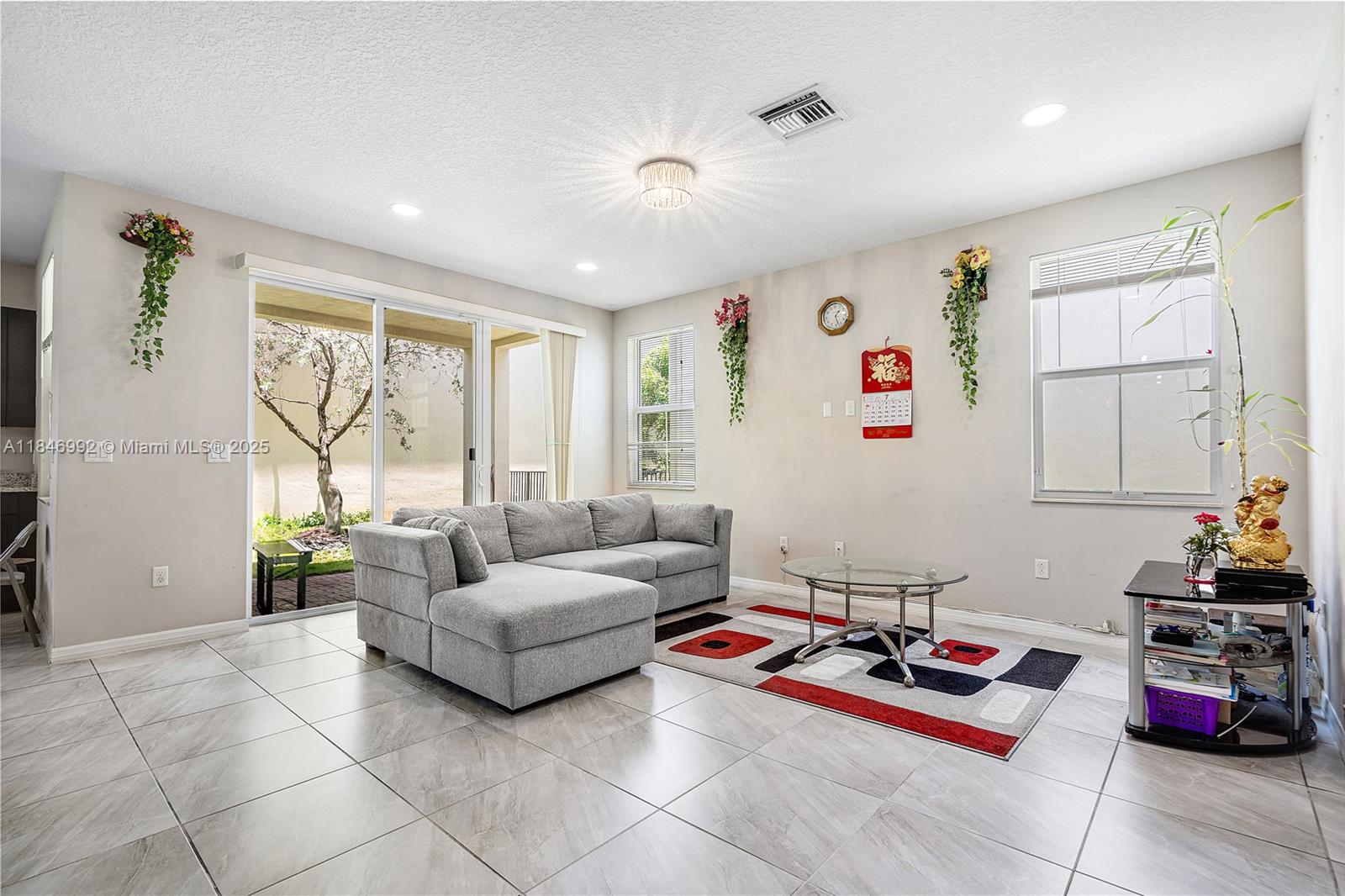 6411 Osprey Landing Street Davie, FL 33314 - Photo 9 of 38 a living room with furniture and a table
