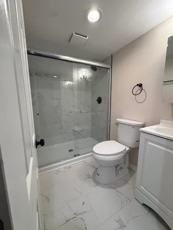 a bathroom with a toilet sink and shower