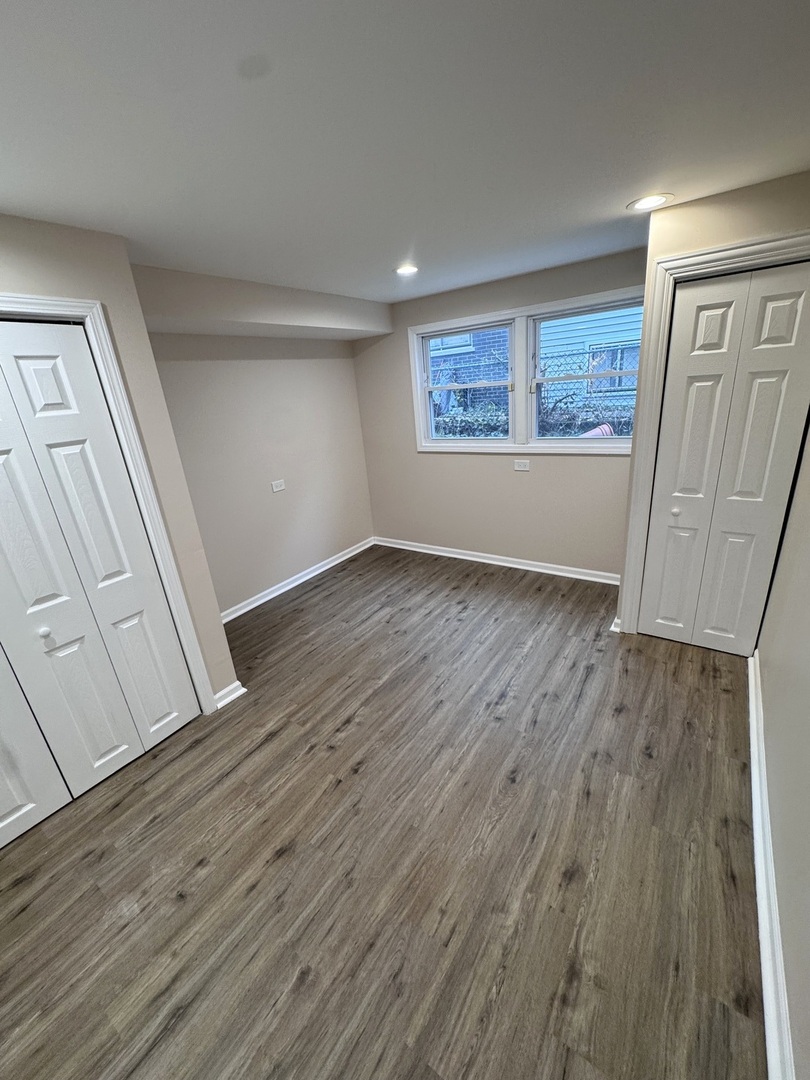 1338 Jill Terrace Homewood, IL 60430 - Photo 18 of 20 an empty room with wooden floor and windows