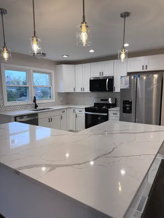 a kitchen with stainless steel appliances a refrigerator sink and microwave