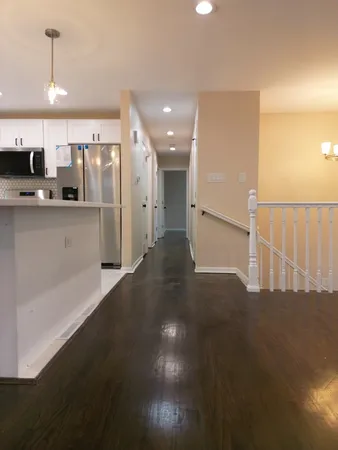 a open kitchen with stainless steel appliances a refrigerator and a sink