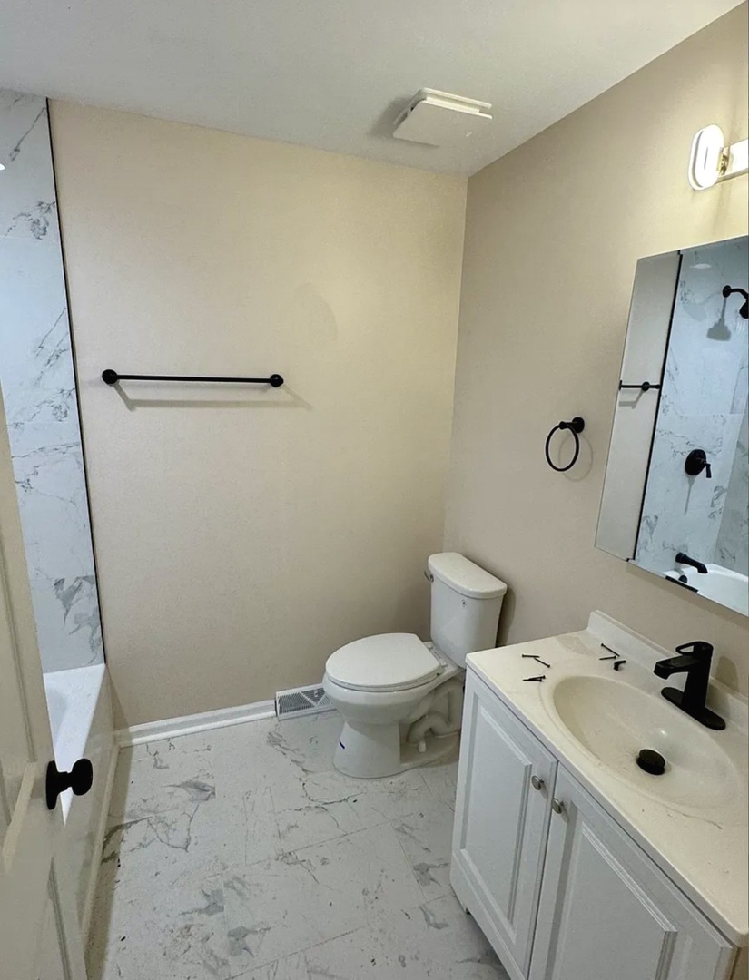 1338 Jill Terrace Homewood, IL 60430 - Photo 8 of 20 a bathroom with a sink a toilet and shower