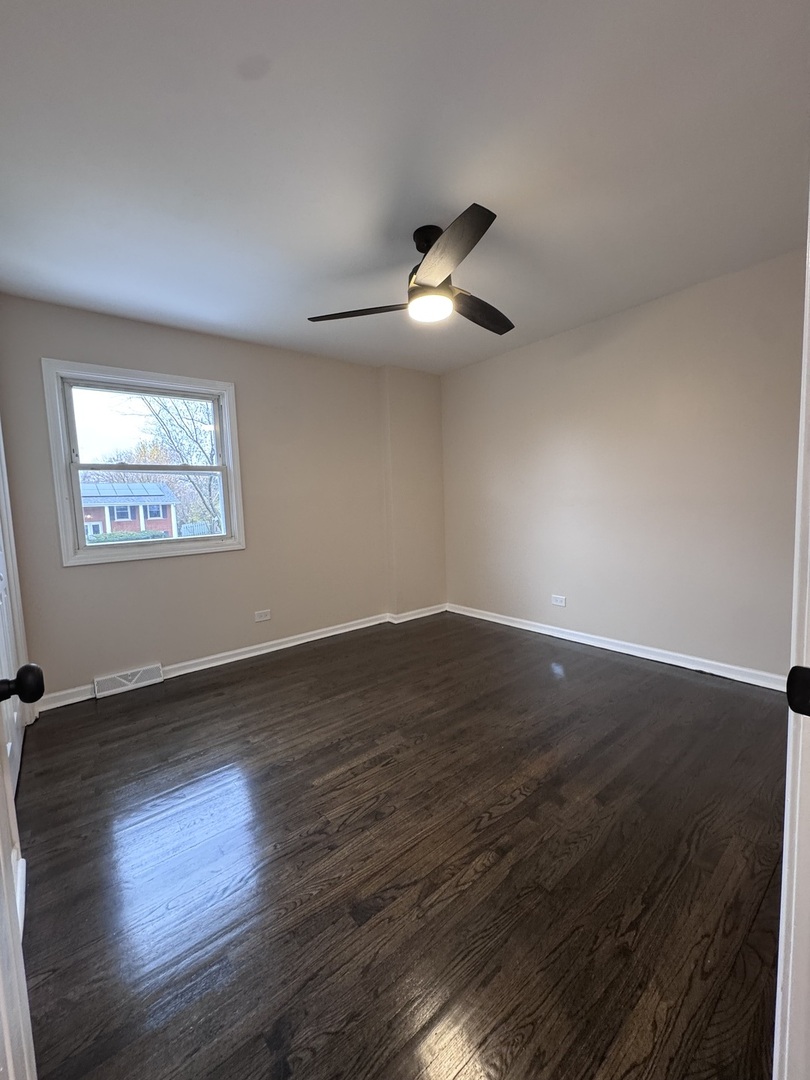 1338 Jill Terrace Homewood, IL 60430 - Photo 9 of 20 a view of empty room with wooden floor and fan