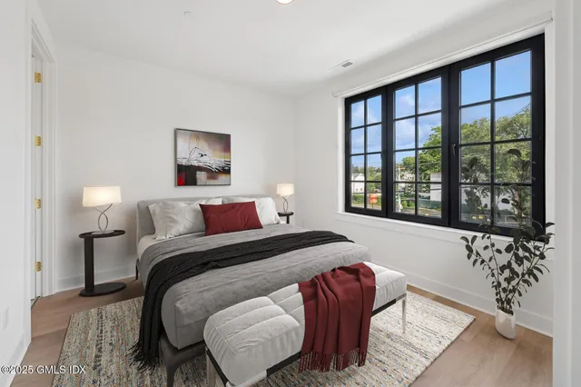 a bedroom with a large bed and a large window