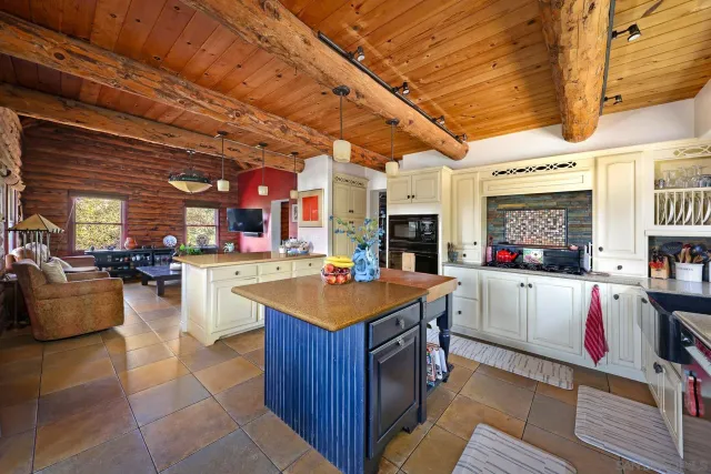 a living room with stainless steel appliances kitchen island granite countertop furniture and a kitchen view