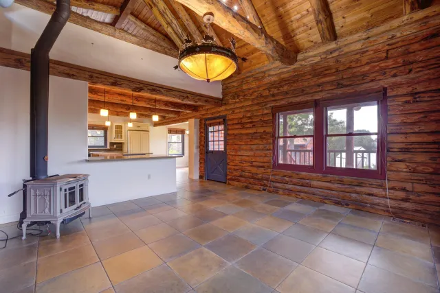 a view of a hallway with wooden floor and a window