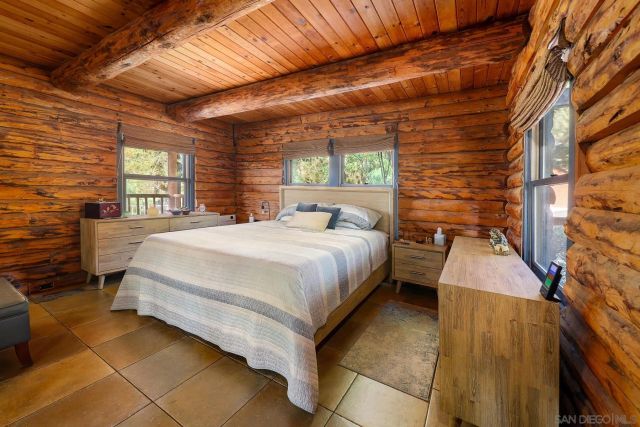 a bedroom with a bed and a wall painting