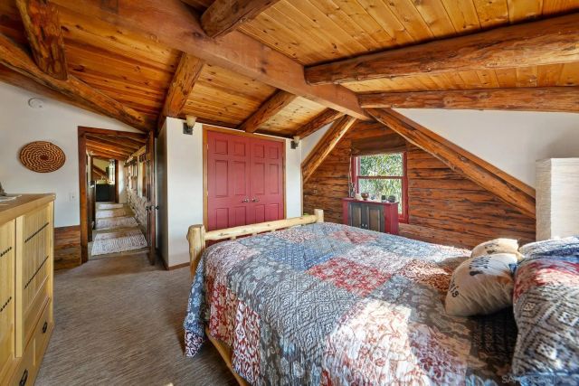 a bed sitting in a bedroom next to a window