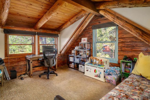 a bedroom with furniture and a large window
