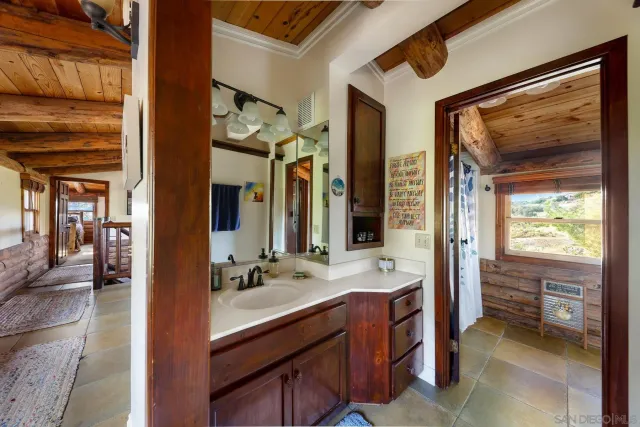 a spacious bathroom with a double vanity sink and a mirror