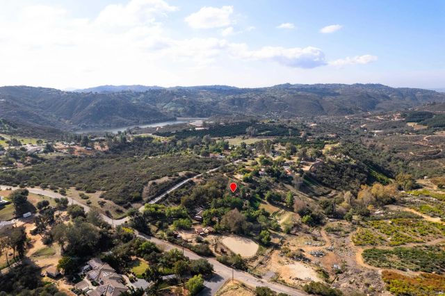an aerial view of a house with a yard and garden