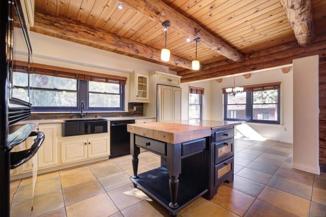 a kitchen with a stove a sink and cabinets