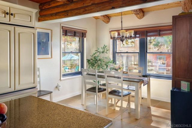 a dining room with wooden floor and a window