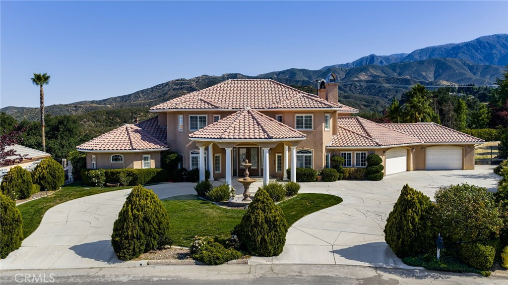 38136 Butterfly Court Yucaipa, CA 92399 - Photo 7 of 71 a front view of a house with a yard and potted plants