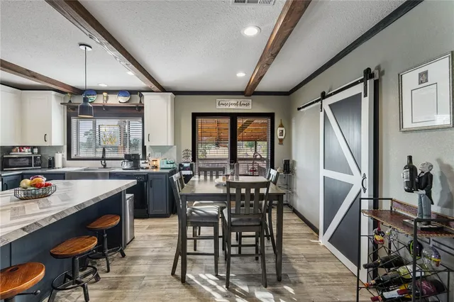 a kitchen with a table chairs stove and cabinets
