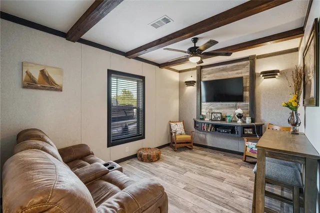 a bedroom with furniture and a flat screen tv