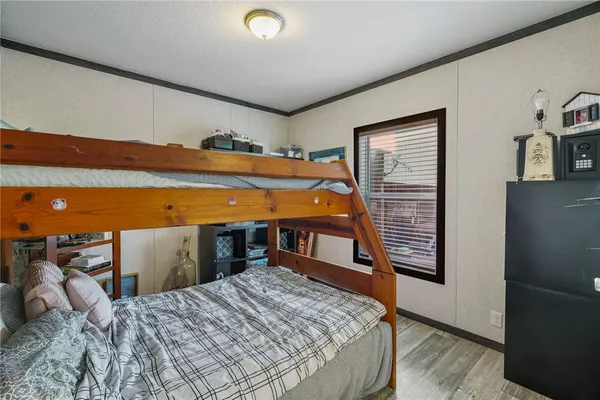 a bedroom with a bed and a ceiling fan