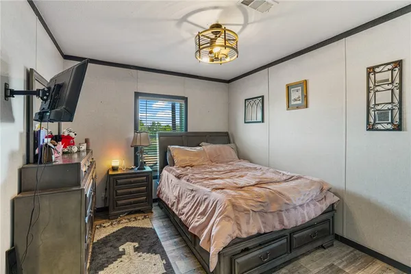 a bedroom with a bed and a chandelier