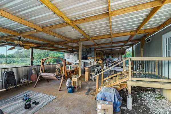 a view of a chairs and table in the patio