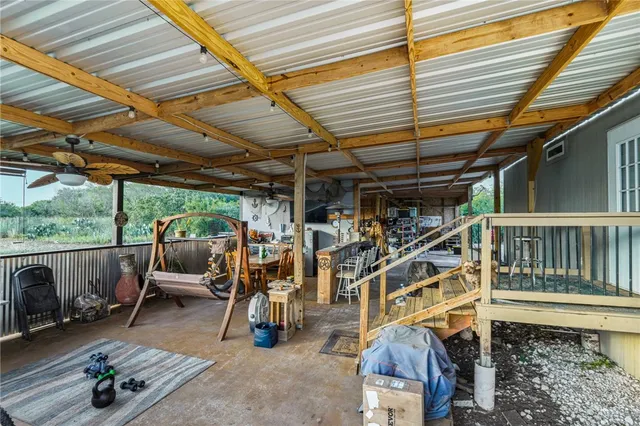 a view of a chairs and table in the patio