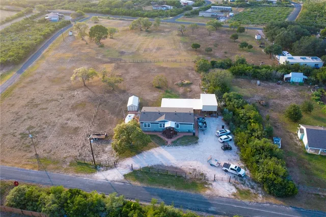 an aerial view of lake and residential houses with outdoor space