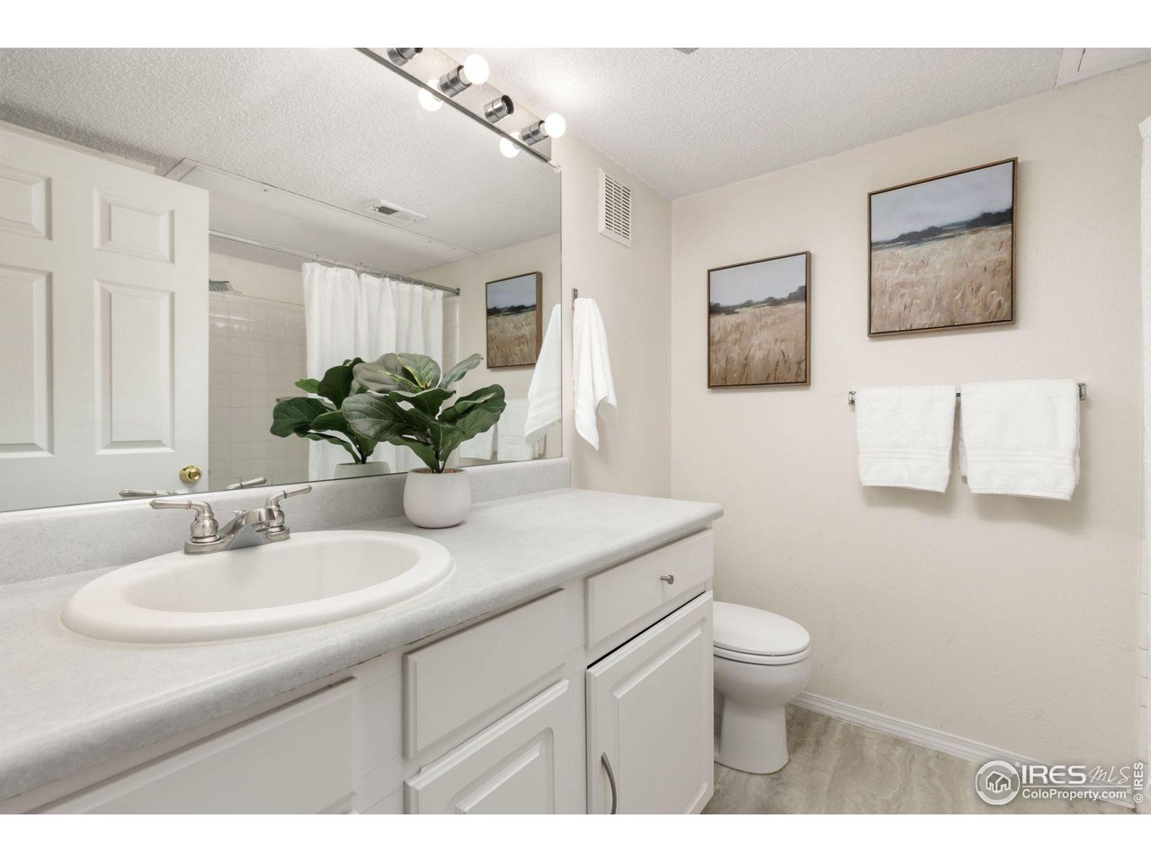 1855 Spaulding Circle Superior, CO 80027 - Photo 16 of 32 a bathroom with a sink toilet and a mirror