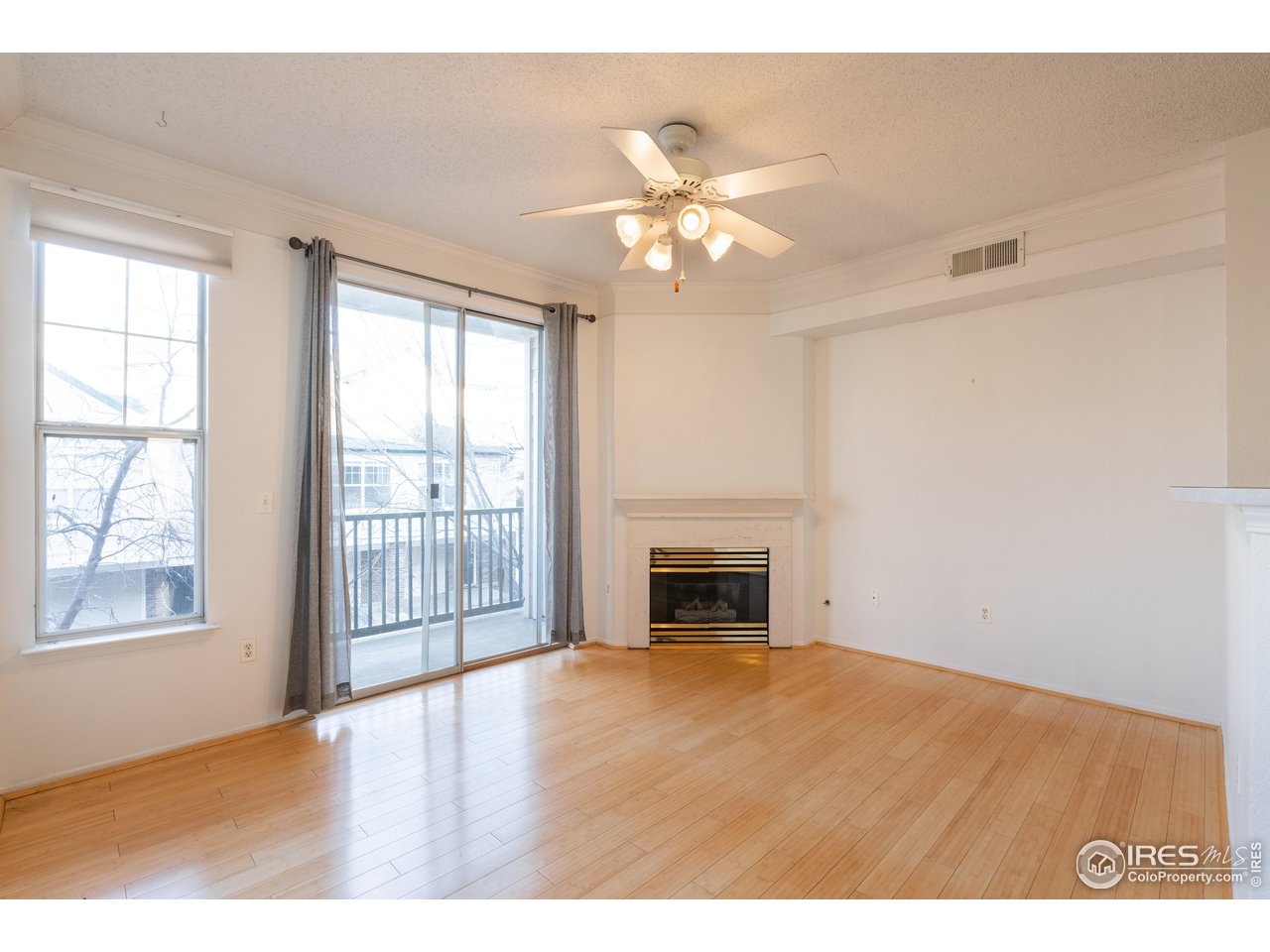 1855 Spaulding Circle Superior, CO 80027 - Photo 3 of 32 a view of empty room with wooden floor and fan