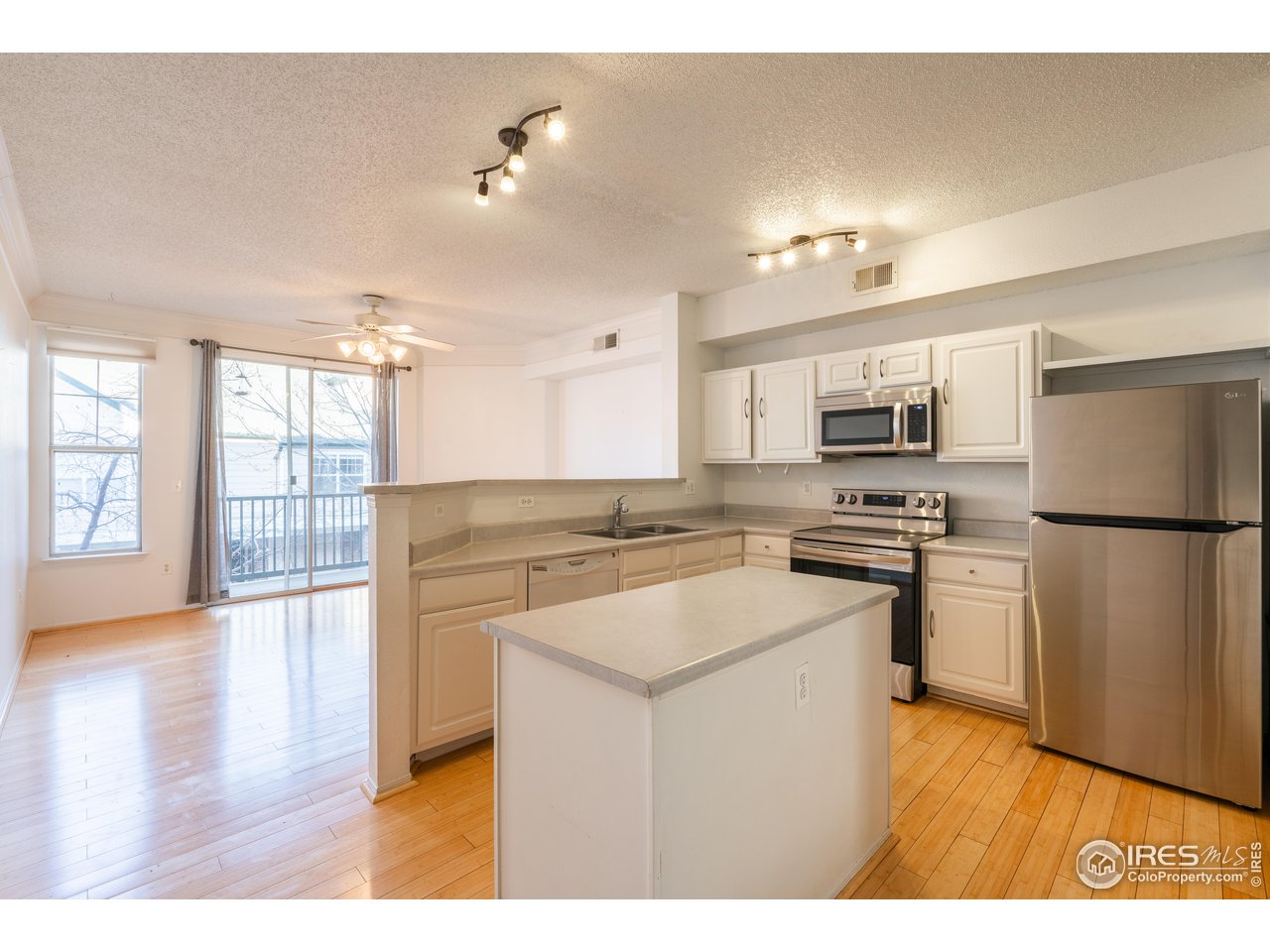 1855 Spaulding Circle Superior, CO 80027 - Photo 7 of 32 a kitchen with a refrigerator a stove top oven a sink and dishwasher with wooden floor